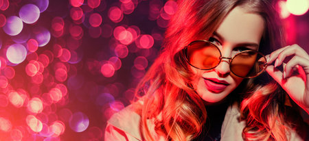 A close up portrait of a beautiful lady wearing sunglasses. Beauty, make-up, style.