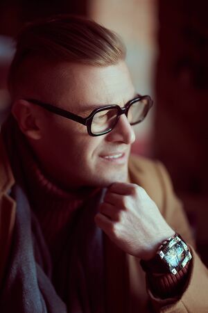 Close up portrait of a stylish attractive businessman in the interior. Optics style.の写真素材