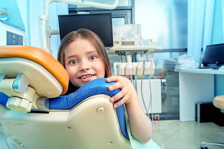 A portrait of a child girl in the cabinet of a dentist. treatment, medicine, hospital.の写真素材
