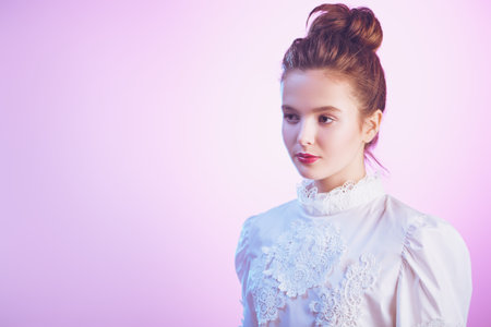Portrait of a beautiful young girl with natural make-up and fresh skin in a light pink haze. Spring...