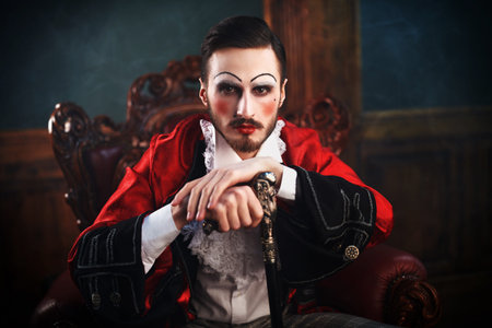 Art, history and fashion. Sophisticated young man with make-up and clothes in the style of the...