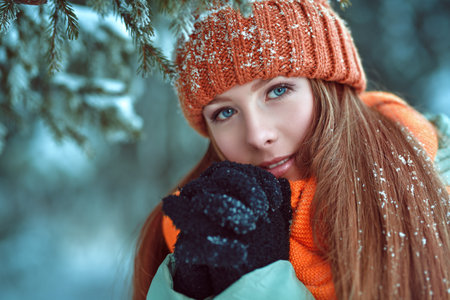 Cute girl teenager standing in a winter park. Winter season. Beauty, fashion.  