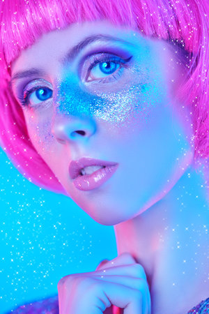 Beauty, makeup and cosmetics concept. Portrait of an attractive girl with shiny glitter freckles and...
