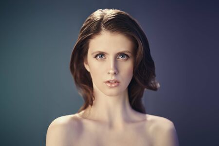 Beauty woman. Portrait of a beautiful young woman with fresh healthy skin and natural make-up. Studio shot. Copy space.の写真素材