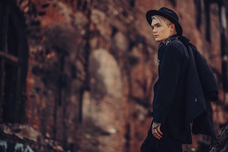 A portrait of a young fair-haired guy walking in the street. Casual fashion, beauty.の写真素材