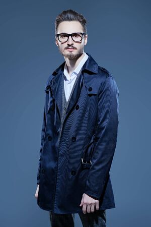 Elegant handsome man in spectacles and fashionable suit. Business style. Studio portrait.の写真素材