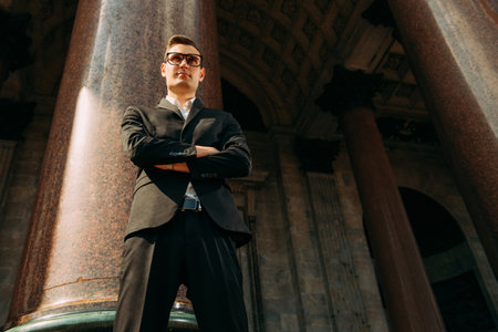 A portrait of a goodlooking young student walking in the street. Men's beauty, fashion.