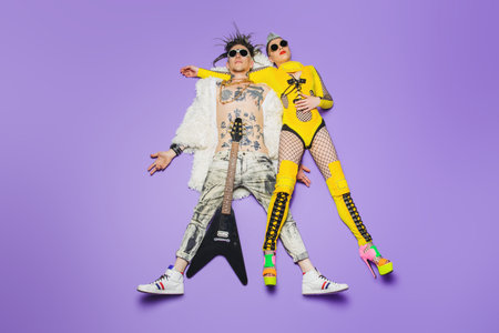 A portrait of two cool young punk people posing in the studio. Casual punk fashion, rock band.
