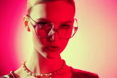 A close up portrait of a confident lady wearing glasses. Beauty, make-up, style.の写真素材