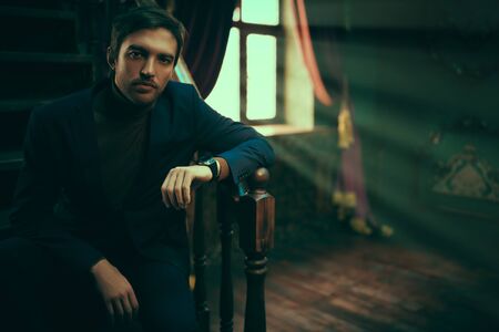 Handsome mature man in elegant formal suit in a luxurious vintage interior. Men's beauty, fashion. Businessman portrait.の写真素材