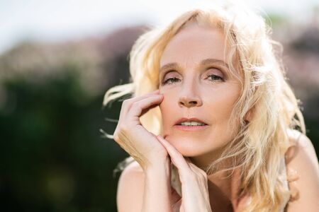 A portrait of an elderly blonde woman in the summer day. Beauty, healthcare.の写真素材