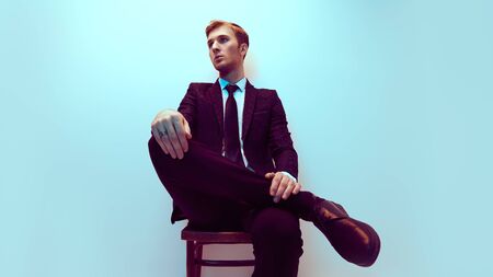 A portrait of a handsome young businessman in a formal suit at studio. Men's fashion.の写真素材