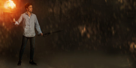 A full length portrait of a young goodlooking guy with a sword. Men casual fashion, Jedi.