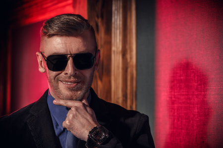 Portrait of a handsome smiling businessman in sunglasses. Men's beauty, fashion. Optics for men.