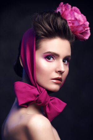 Elegant fashion model with a floral headdress. Fashion, clothing style, accessories. Studio portrait.の写真素材