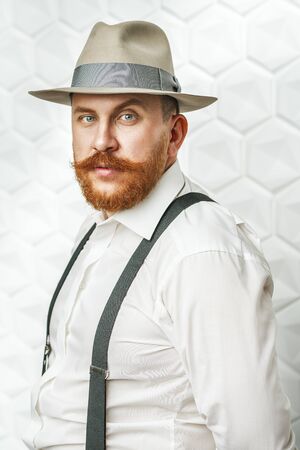 A portrait of a happy man posing in the studio over the white background. Men's beauty, fashion, style.の写真素材