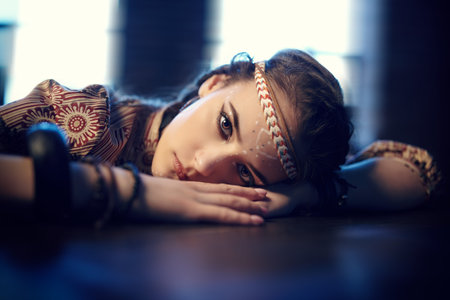 Portrait of a beautiful young woman with hairstyle and make-up in boho style. Bohemian, modern...
