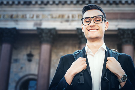 Business and vacation. Portrait of a happy goodlooking business man traveling the world. Business trip.の写真素材