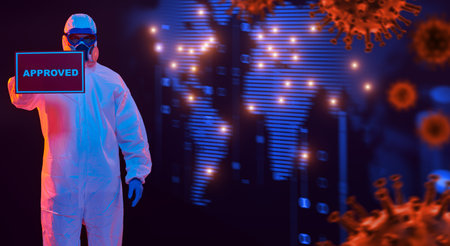 COVID-19 concept. A doctor in a protective suit holds a sign approved on the background of a...