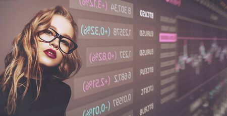 Business concept. Portrait of a beautiful businesswoman on the background with business charts and graphs. Financial market, economy concept. Copy space.の写真素材