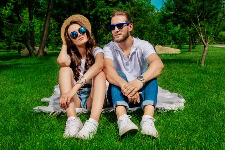 Happy young people in love in the park on a sunny summer day. Summer holidays. Love concept.の写真素材