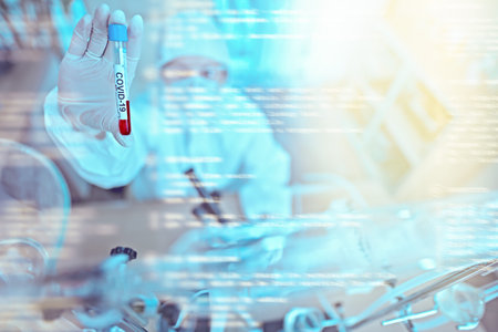COVID-19. Doctor, microbiologist, scientist in a protective suit shows a test tube with a coronavirus blood sample in the laboratory. Coronavirus test. Medical network interface.の写真素材