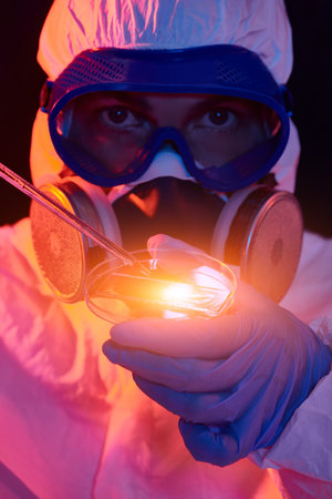 COVID-19 or 2019-nCoV. Close-up portrait of a scientist microbiologist in a protective PPE suit...
