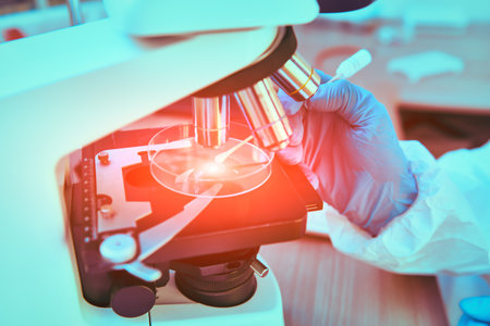 COVID-19 or SARS-CoV-2. Close-up of a drop of blood under a microscope. A scientist makes a study of coronavirus in the laboratory. Innovative technologies in medicine.の写真素材