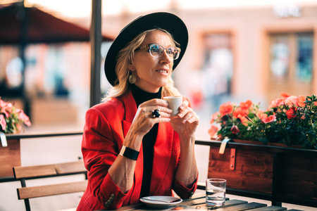 A portrait of an elegant elderly woman at the cafe. Beauty, fashion.
