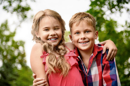 Portrait of a happy little children walking in the Park. Summer holidays. Children's fashion.