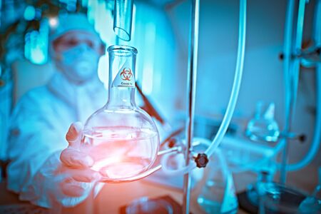 COVID-19 or SARS-CoV-2. Doctor, microbiologist, scientist in a protective suit, makes a study of coronavirus in the laboratory. Coronavirus test.の写真素材