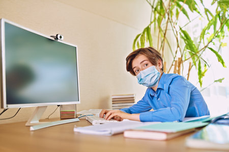 Coronavirus and life. Boy schoolboy student stays home at distance learning due to quarantine...
