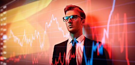 Men's fashion. Portrait of a handsome young businessman in a formal suit and glasses in red light. Business man studio portrait.の写真素材
