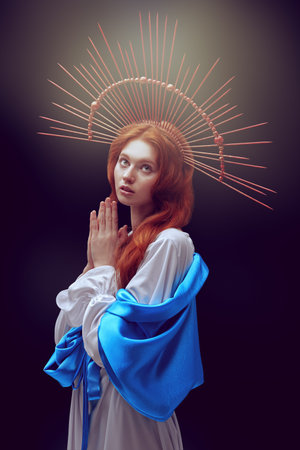 The Virgin Mary portrait on a dark background with rays of light. Modern art in religion.