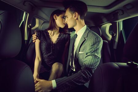 Glamorous  couple in a car. People in love.の写真素材