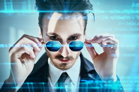 Modern stylish man touches digital screen. Innovative digital technologies, digital gadgets. Male fashion.の写真素材