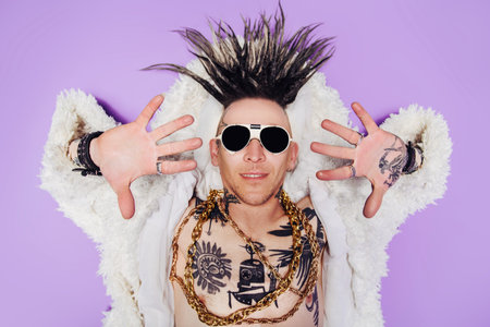A portrait of a cool young punk man posing in the studio. Casual punk fashion, beauty.