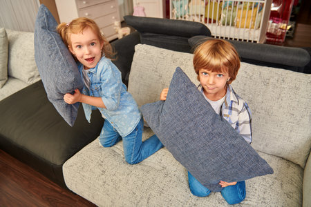Happy children playing together in a living room at home. Family concept. Happy childhood.