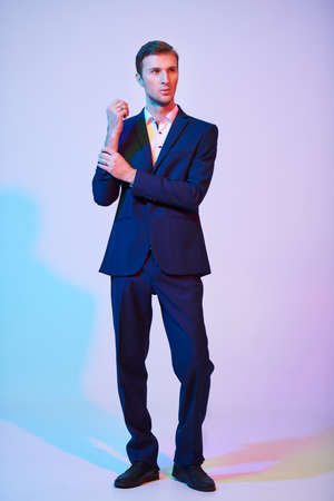 Full length portrait of a handsome young businessman in a formal suit at studio. Men's fashion.の写真素材