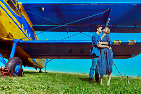 Full length portrait of a beautiful passionate couple in love is going to travel by plane. Adventure...
