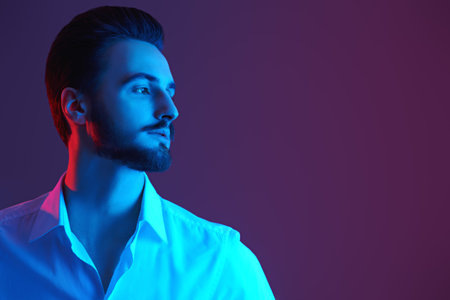 Portrait of an elegant young man in white shirt looking away thoughtfully. Men's beauty, fashion....