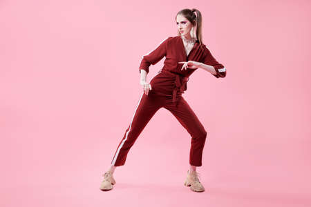 Fashion concept. Sport chic style. Full length portrait of a pretty girl in fashionable sportswear.の写真素材
