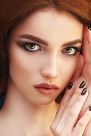 Beauty concept. Close-up portrait of a beautiful girl looking at camera. Make-up and cosmetics,...