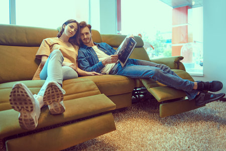 Beautiful young people in love spending time together at home. Happy couple. Home interior,...