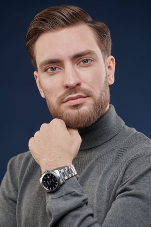 Portrait of a good-looking handsome man. Men's beauty, fashion. Wrist Watch style.