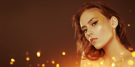 Make-up and cosmetics. Portrait of a gorgeous young woman with golden make-up on a dark background....