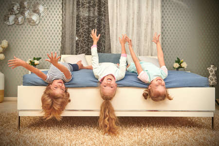Happy children play together at a bedroom at home. Family concept.の写真素材