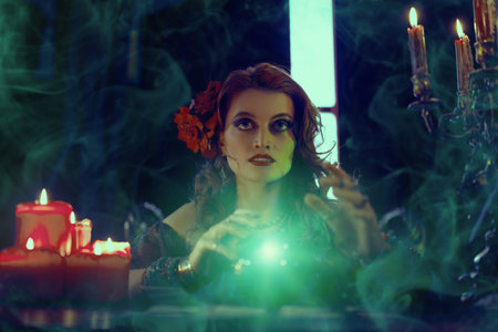 Bewitching fortune teller woman reading future on magical crystal ball.