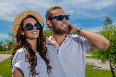 Happy young people in love in the park on a sunny summer day. Summer holidays. Love concept.の写真素材