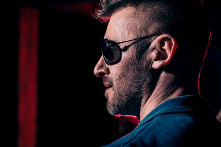 A close up portrait of a brutal handsome man in sunglasses. Men's beauty, fashion. Optics for men.の写真素材